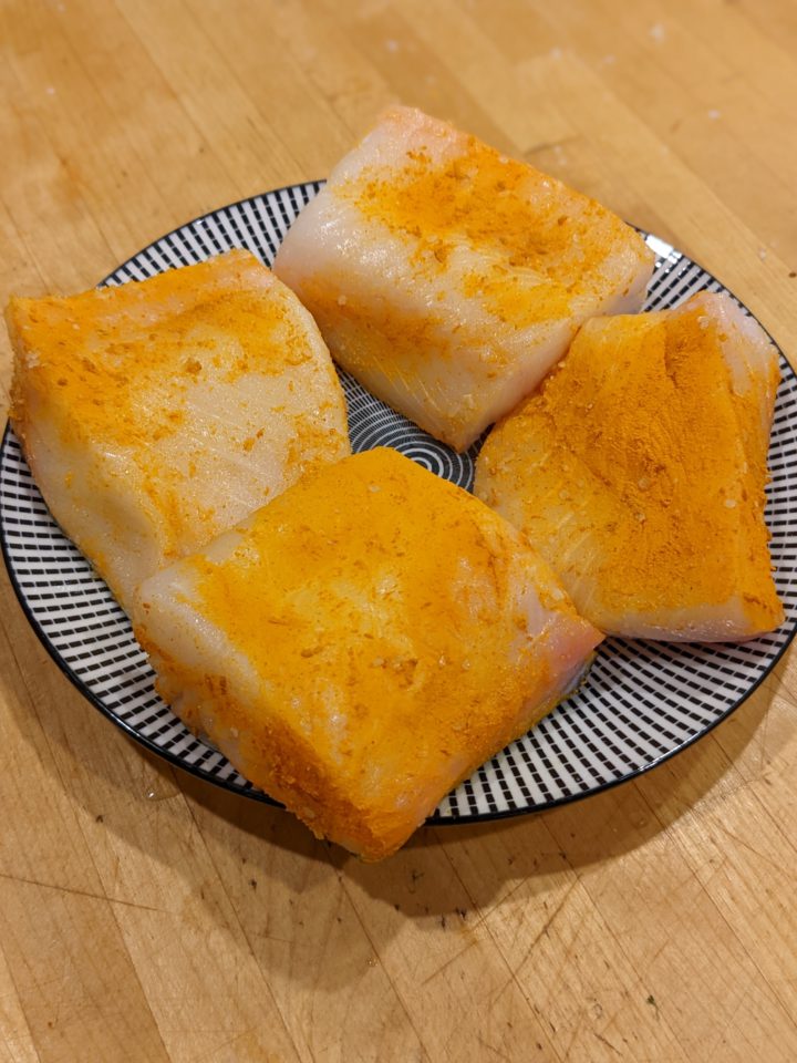 Fish steaks marinating in salt and turmeric