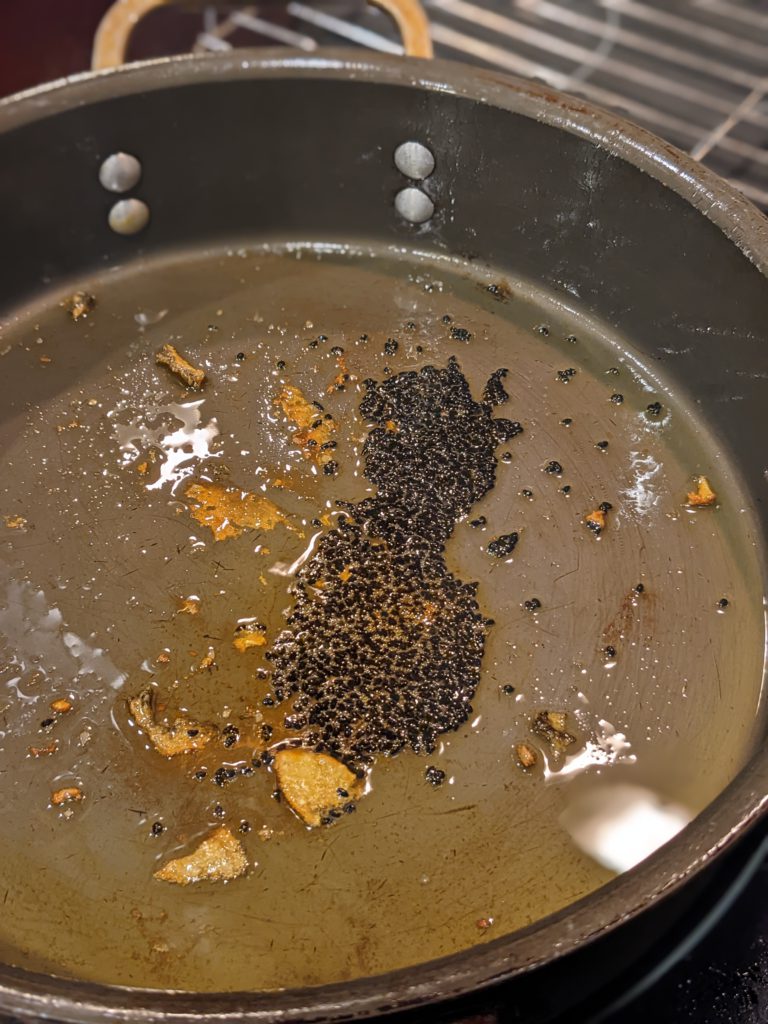 Onion seeds sautéing in a pan