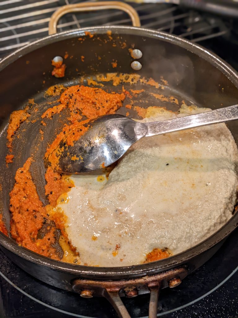 Mustard seed paste added to a trying pan